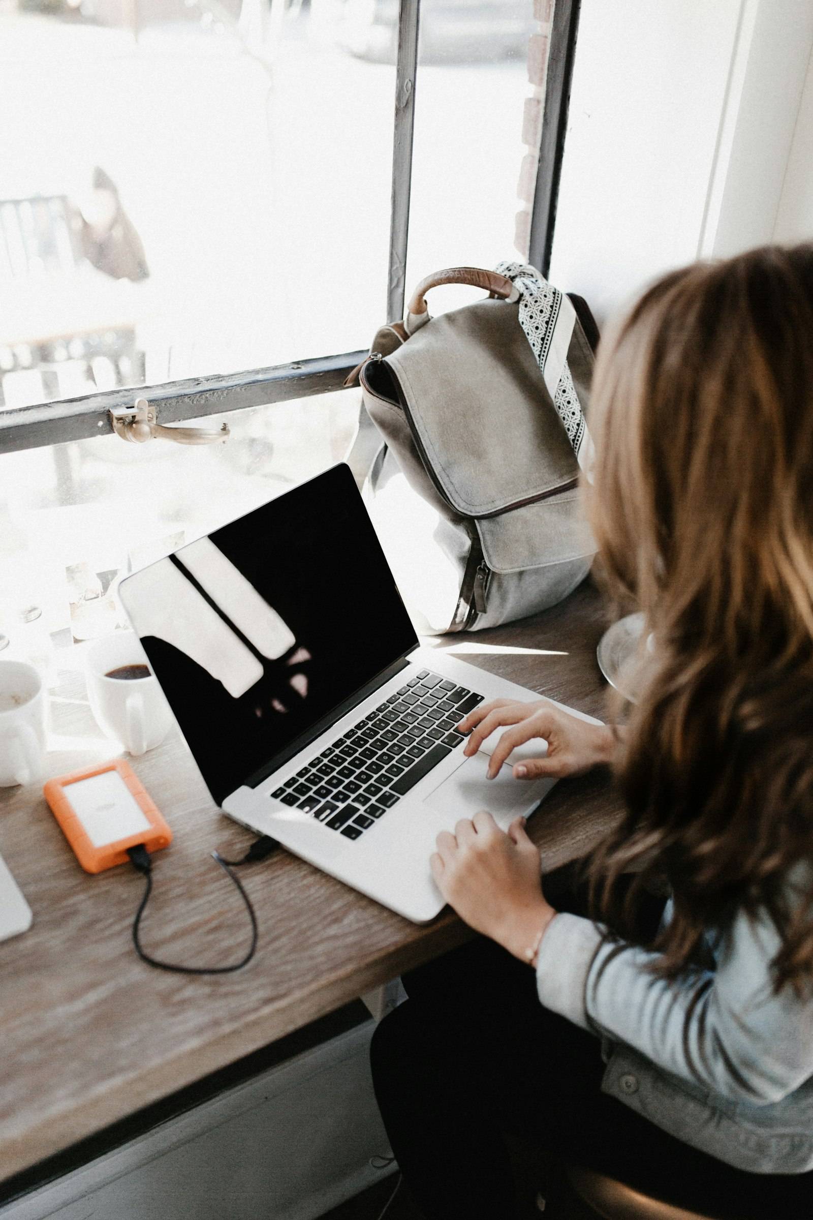A law student working through case study practice on a laptop